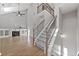 Open-concept living room showcasing a fireplace, staircase, and hardwood floors offering comfort and style at 2766 Wander Ln, Alpharetta, GA 30022