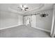 Large main bedroom with tray ceiling, barn door, and a doorway to an ensuite bathroom at 2766 Wander Ln, Alpharetta, GA 30022