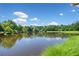 Scenic view of a tranquil pond surrounded by lush greenery and a clear blue sky at 2766 Wander Ln, Alpharetta, GA 30022