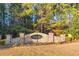Stone entranceway with manicured landscaping and a decorative sign at 3110 Haverhill Ne Cv, Conyers, GA 30012