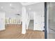 Bright, open foyer with wood floors and staircase, leading into the living area at 3110 Haverhill Ne Cv, Conyers, GA 30012
