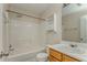 Bright bathroom featuring a tub with shower, toilet, vanity with sink, and shelving for storage at 3623 Thurleston Sw Ct, Marietta, GA 30008