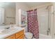 Traditional bathroom featuring a tub with shower, toilet, vanity with sink, and shelving for storage at 3623 Thurleston Sw Ct, Marietta, GA 30008