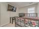 Bright bedroom features a large bed, desk, television, and closet with carpet flooring at 3623 Thurleston Sw Ct, Marietta, GA 30008