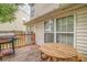 Backyard wooden deck featuring a grill, table, and seating with sliding glass doors at 3623 Thurleston Sw Ct, Marietta, GA 30008