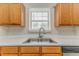 Kitchen area with double sink, window, and light wood cabinetry at 3623 Thurleston Sw Ct, Marietta, GA 30008