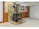 Basement with a stone fireplace and wood-burning stove creates a cozy atmosphere at 431 Keeler Woods Nw Dr, Marietta, GA 30064