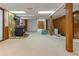 Finished basement space with stone accented fireplace, neutral carpeting and exposed support beams at 431 Keeler Woods Nw Dr, Marietta, GA 30064