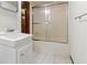 Bathroom with sliding glass door shower and white tile flooring at 431 Keeler Woods Nw Dr, Marietta, GA 30064