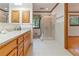 Well-lit bathroom with a double vanity, granite counters, and a glass-enclosed shower at 431 Keeler Woods Nw Dr, Marietta, GA 30064