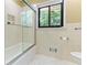 Bathroom featuring a shower-over-bath, and a black framed window at 431 Keeler Woods Nw Dr, Marietta, GA 30064