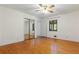 Bedroom with hardwood floors, a ceiling fan, and a mirrored closet at 431 Keeler Woods Nw Dr, Marietta, GA 30064