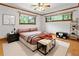 Staged bedroom with hardwood floors, ceiling fan, natural light, and decorative trim at 431 Keeler Woods Nw Dr, Marietta, GA 30064