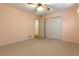 Carpeted bedroom with a ceiling fan and double door closet for ample storage at 431 Keeler Woods Nw Dr, Marietta, GA 30064