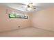 Bright bedroom featuring neutral carpet, a ceiling fan, and a window offering natural light at 431 Keeler Woods Nw Dr, Marietta, GA 30064