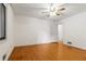 Bedroom with hardwood floors, ceiling fan, closet, and a door to the hallway at 431 Keeler Woods Nw Dr, Marietta, GA 30064