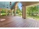 Spacious covered porch with wooden floors, ceiling fans, and elegant columns, perfect for outdoor living at 431 Keeler Woods Nw Dr, Marietta, GA 30064