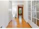 Hardwood floors lead to a bright home interior with closet and glass paneled door at 431 Keeler Woods Nw Dr, Marietta, GA 30064