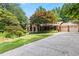Charming brick home with mature landscaping, covered front porch, and convenient two-car garage at 431 Keeler Woods Nw Dr, Marietta, GA 30064