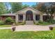 Inviting brick home with a covered porch, landscaped front yard, and patterned concrete driveway at 431 Keeler Woods Nw Dr, Marietta, GA 30064