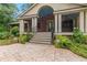 Beautiful brick home with a covered porch, lovely landscaping, and charming stairs leading to the front door at 431 Keeler Woods Nw Dr, Marietta, GA 30064
