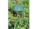 Close up view of a '431 Loop Omi's Garden' address sign nestled amongst dense foliage at 431 Keeler Woods Nw Dr, Marietta, GA 30064