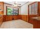 Cozy breakfast nook in kitchen featuring a ceiling fan, wood paneling, and a view to the exterior at 431 Keeler Woods Nw Dr, Marietta, GA 30064