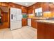 Spacious kitchen boasts granite counters, stainless appliances, wood cabinetry, and tile floors at 431 Keeler Woods Nw Dr, Marietta, GA 30064