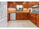 Traditional kitchen featuring granite countertops, wood cabinets, tile flooring and modern appliances at 431 Keeler Woods Nw Dr, Marietta, GA 30064