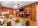 Comfortable living room with a fireplace, built-in bookcase, and wood-paneled walls at 431 Keeler Woods Nw Dr, Marietta, GA 30064