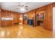 Living room with wood-paneled walls, fireplace, built-in bookcase, and hardwood flooring at 431 Keeler Woods Nw Dr, Marietta, GA 30064