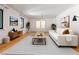 Staged living room with hardwood floors, white sofa, neutral rug, and modern decor at 431 Keeler Woods Nw Dr, Marietta, GA 30064