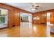 Open living room with hardwood floors, wood-paneled walls, and access to multiple rooms at 431 Keeler Woods Nw Dr, Marietta, GA 30064