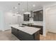 Bright kitchen featuring an island, stainless appliances, pendant lighting, and stylish cabinetry at 548 Sawnee Village Blvd # D54, Cumming, GA 30040