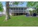 Expansive backyard with a screened-in porch and inviting fire pit area at 792 Mimosa Se Dr, Marietta, GA 30060