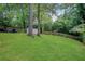 Expansive backyard with mature trees and lush green lawn at 792 Mimosa Se Dr, Marietta, GA 30060