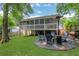 Large backyard featuring a screened porch, fire pit, and ample lawn space at 792 Mimosa Se Dr, Marietta, GA 30060