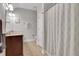 Bathroom featuring double sink vanity, tile floors, and patterned shower curtain at 792 Mimosa Se Dr, Marietta, GA 30060