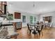 Well-lit kitchen and dining area with wood cabinets, stainless appliances, and hardwood floors at 792 Mimosa Se Dr, Marietta, GA 30060
