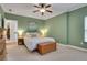Bedroom boasts neutral colors, soft carpet, a ceiling fan, and natural light at 792 Mimosa Se Dr, Marietta, GA 30060