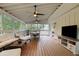 Inviting screened-in porch with comfortable seating, a TV, and ceiling fans, perfect for relaxing and entertaining at 792 Mimosa Se Dr, Marietta, GA 30060