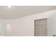 Brightly lit bedroom featuring neutral walls, carpet, and two doors, one of which is a closet at 12086 Conrad Cir, Hampton, GA 30228