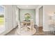 Cozy dining area with a round table bathed in sunlight, creating a pleasant dining experience at 12086 Conrad Cir, Hampton, GA 30228