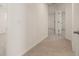 Neutral hallway with carpeted floors and natural lighting throughout at 12086 Conrad Cir, Hampton, GA 30228