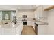 Stylish kitchen featuring white cabinets, stainless steel appliances, granite countertops, and a breakfast bar at 12086 Conrad Cir, Hampton, GA 30228