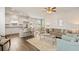 Open concept living space featuring a modern kitchen and living room with coordinated furniture at 12086 Conrad Cir, Hampton, GA 30228