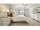 Relax in this main bedroom featuring tray ceilings and plush carpeted floors at 12086 Conrad Cir, Hampton, GA 30228