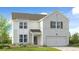 Charming two-story home featuring a brick facade, attached garage, and a well-manicured lawn at 1405 Windance Lake Dr, Loganville, GA 30052