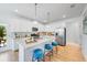 Modern kitchen with white cabinets, stainless steel appliances, granite countertops and a center island with seating at 1405 Windance Lake Dr, Loganville, GA 30052