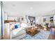Spacious living room featuring plush seating, modern decor, with abundant natural light, and an open floor plan at 1405 Windance Lake Dr, Loganville, GA 30052